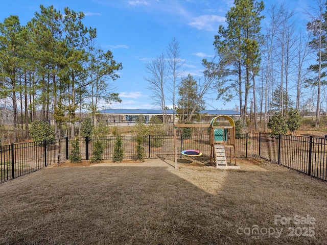 view of playground with a lawn and fence