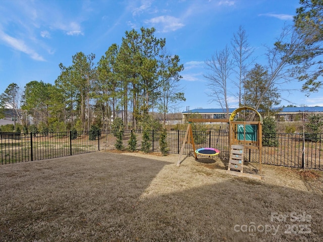 view of playground with fence and a lawn