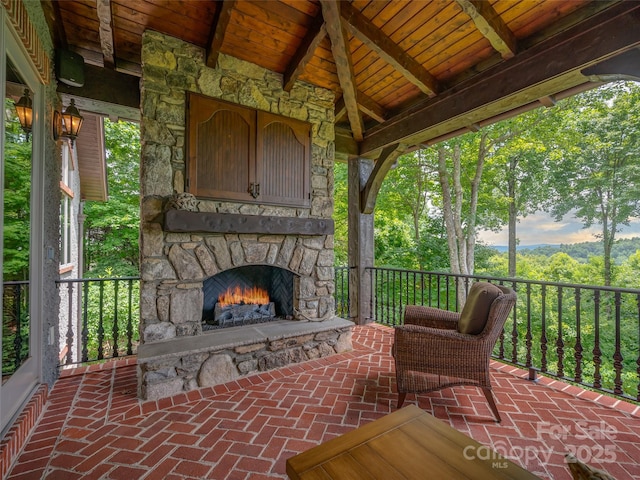 view of patio with an outdoor stone fireplace