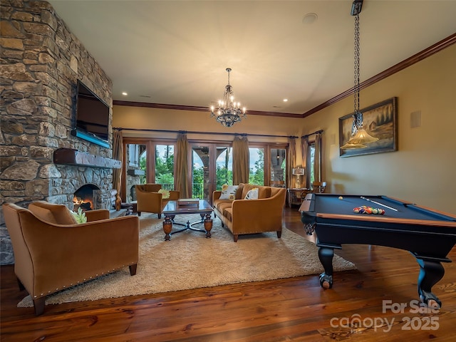 game room featuring crown molding, a fireplace, and wood finished floors