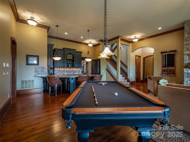 game room with dark wood-style floors, arched walkways, recessed lighting, visible vents, and baseboards