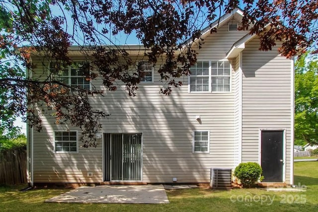 back of property featuring a yard, cooling unit, and a patio