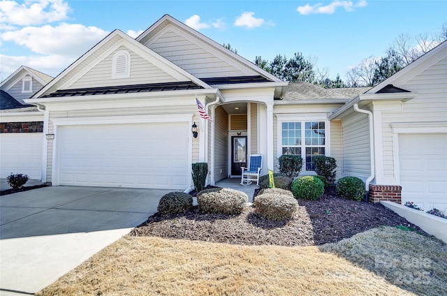 view of front of house with metal roof, concrete driveway, a standing seam roof, and an attached garage