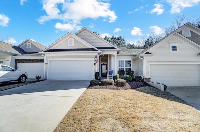 view of front of property with a standing seam roof, driveway, and metal roof