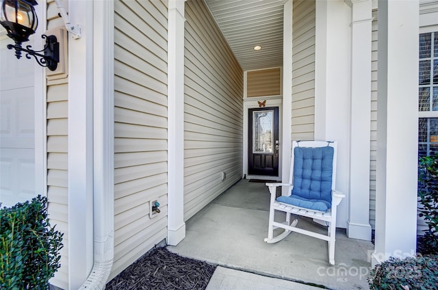 property entrance featuring a garage and covered porch