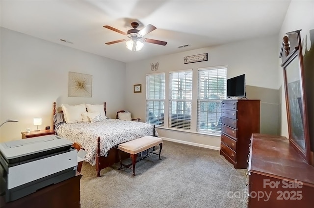 bedroom featuring ceiling fan, carpet floors, visible vents, and baseboards