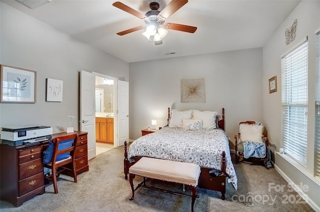 bedroom featuring visible vents, light carpet, and multiple windows