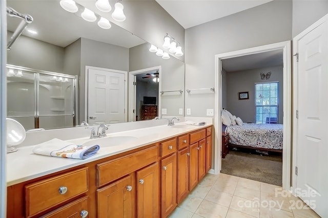 ensuite bathroom with double vanity, a stall shower, a sink, ensuite bath, and tile patterned flooring