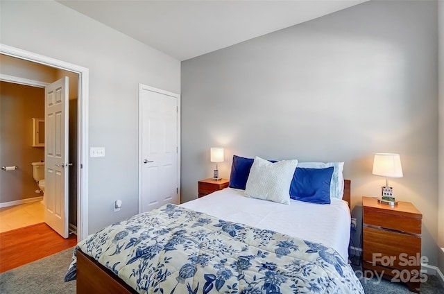 bedroom featuring baseboards and wood finished floors