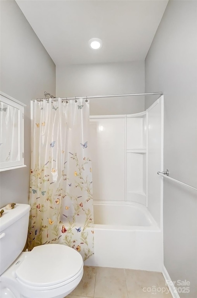 bathroom with shower / bath combo with shower curtain, toilet, and tile patterned floors