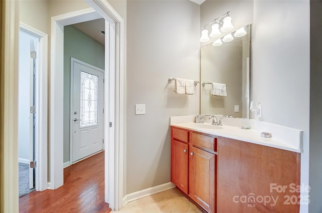 bathroom featuring baseboards and vanity