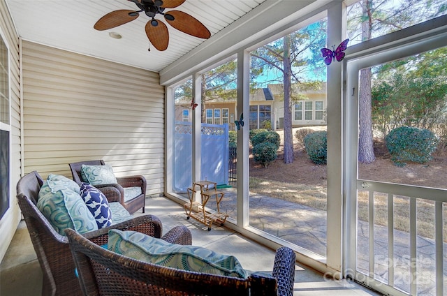 sunroom featuring ceiling fan