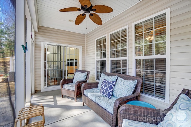 sunroom featuring a ceiling fan