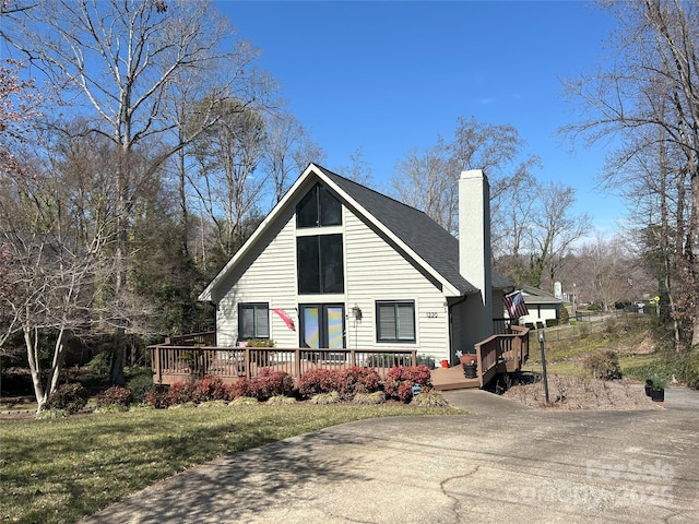 view of front of home with a chimney and a wooden deck