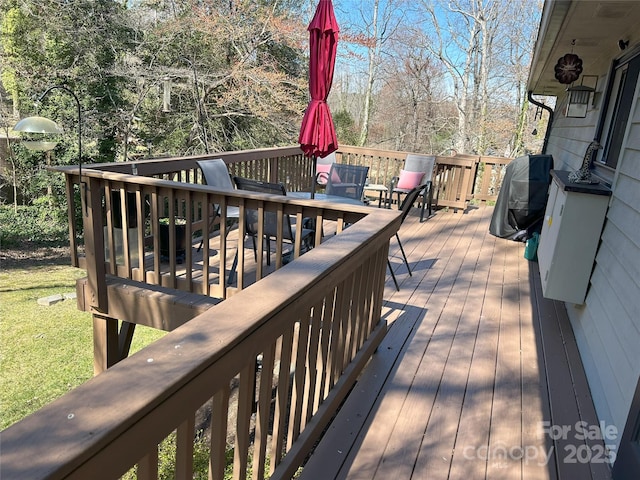 wooden terrace with outdoor dining area