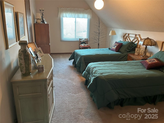 carpeted bedroom with lofted ceiling