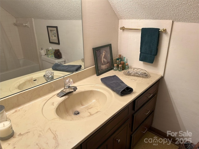 bathroom with vanity, toilet, bathtub / shower combination, and a textured ceiling