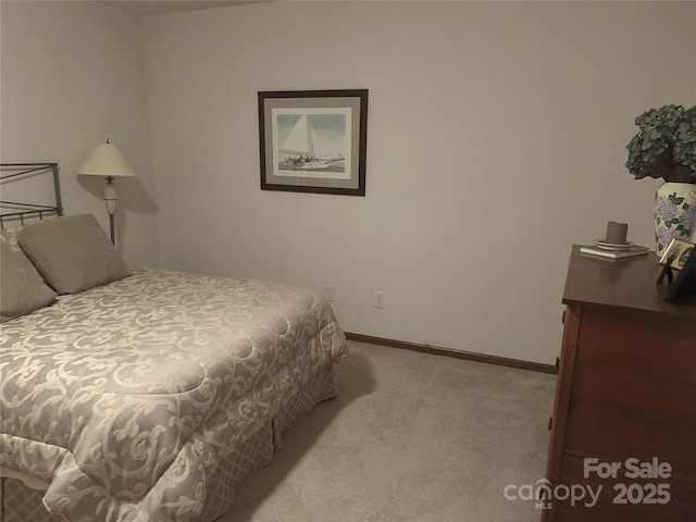 bedroom featuring baseboards and carpet