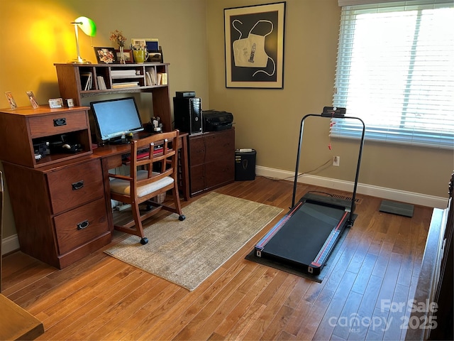 office area featuring baseboards and wood finished floors