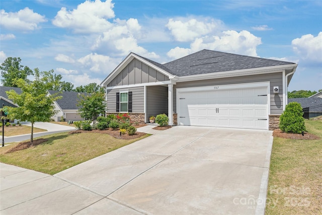 craftsman inspired home with an attached garage, board and batten siding, a front yard, stone siding, and driveway