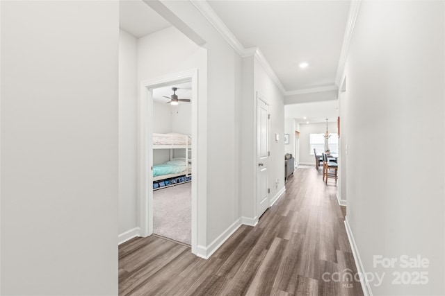 hall featuring ornamental molding, recessed lighting, baseboards, and wood finished floors