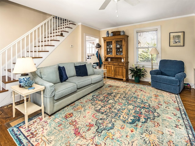 living area featuring crown molding, stairway, and wood finished floors