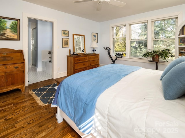 bedroom with ceiling fan, connected bathroom, baseboards, and wood finished floors