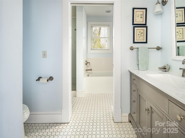 full bathroom with toilet, a bathing tub, vanity, baseboards, and walk in shower