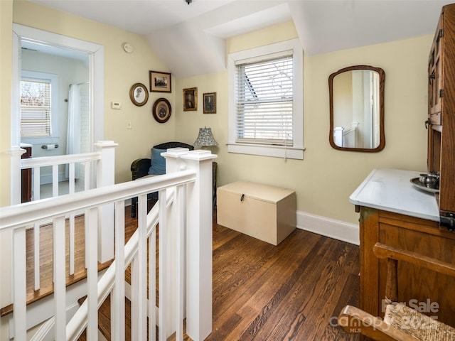 bedroom with dark wood-type flooring and baseboards