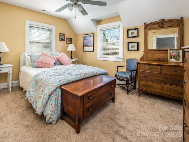 bedroom featuring lofted ceiling, multiple windows, visible vents, and light colored carpet