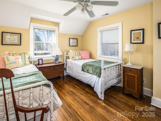 bedroom with baseboards, multiple windows, visible vents, and dark wood-style flooring