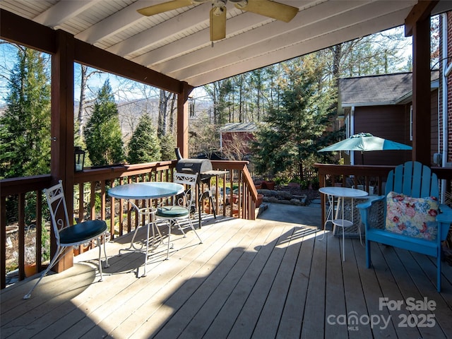 deck featuring a ceiling fan and outdoor dining area