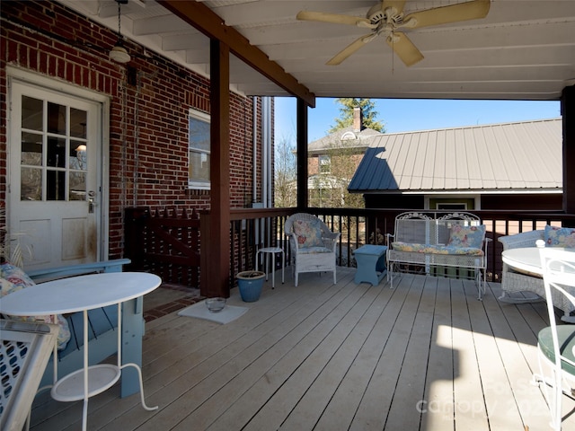 wooden terrace featuring a ceiling fan