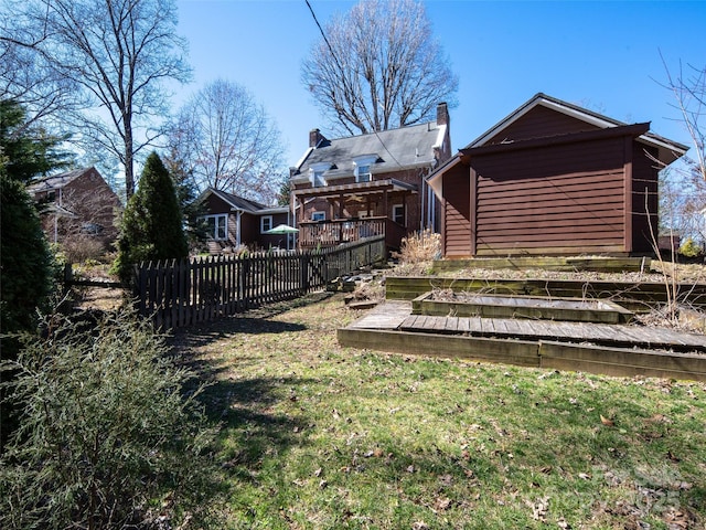 view of yard featuring fence and a wooden deck