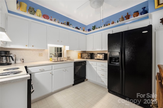 kitchen with white cabinets, a sink, light countertops, black appliances, and backsplash