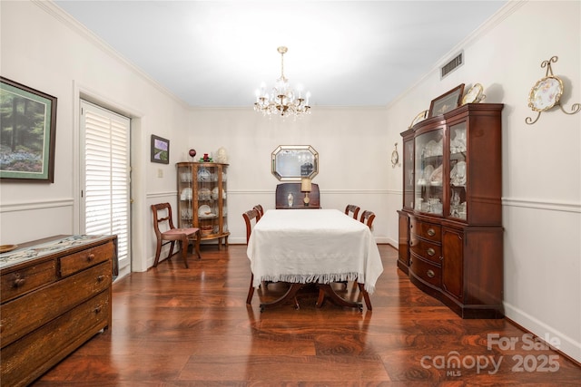 dining area featuring ornamental molding, visible vents, an inviting chandelier, and wood finished floors