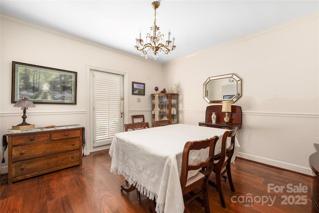 bedroom with dark wood-style floors, a chandelier, ornamental molding, and baseboards