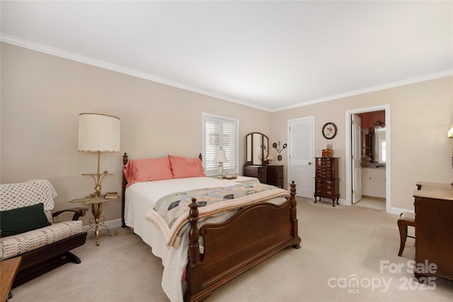 bedroom with light colored carpet, crown molding, baseboards, and ensuite bathroom