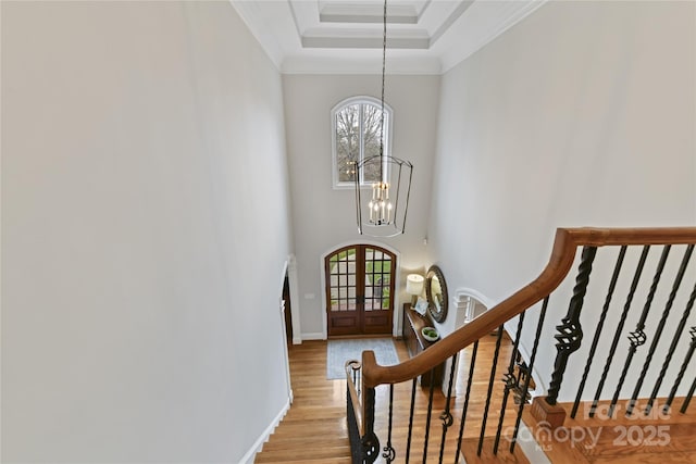 entryway featuring a chandelier, stairs, ornamental molding, french doors, and wood finished floors