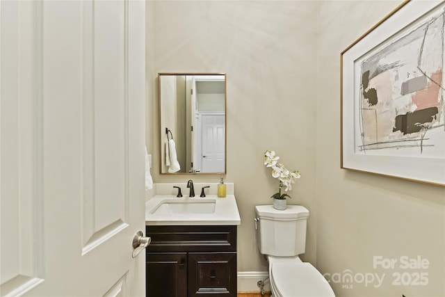 bathroom featuring toilet and vanity