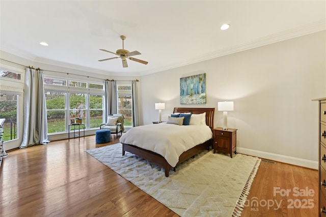 bedroom featuring recessed lighting, baseboards, light wood-style floors, and ornamental molding