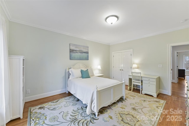 bedroom featuring light wood finished floors, a closet, and baseboards