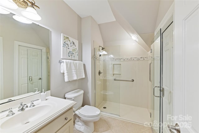 bathroom featuring vanity, a shower stall, toilet, and tile patterned floors