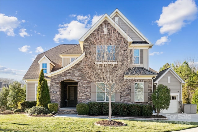 craftsman inspired home with stone siding, a standing seam roof, and a front lawn