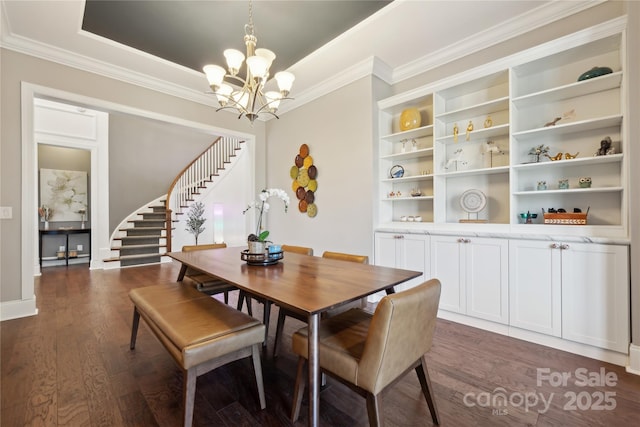 dining area with a chandelier, dark wood-type flooring, ornamental molding, stairway, and a raised ceiling