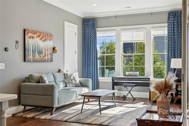 sitting room with visible vents, crown molding, baseboards, and wood finished floors