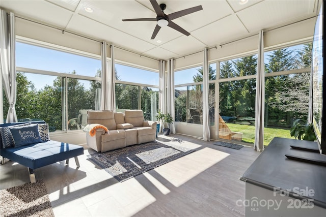 sunroom / solarium featuring ceiling fan