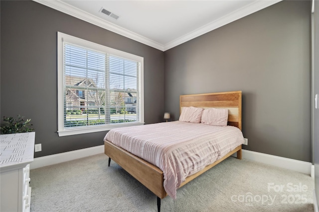 carpeted bedroom with crown molding, visible vents, and baseboards