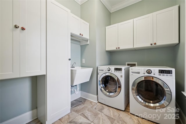 laundry room featuring separate washer and dryer, a sink, baseboards, ornamental molding, and cabinet space