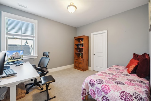 bedroom with light colored carpet, visible vents, and baseboards